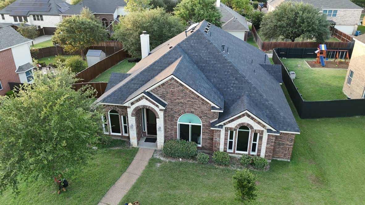Brick ranch home with a new shingle roof and front lawn